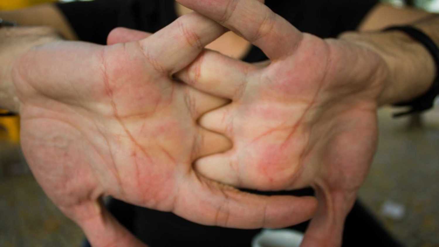 Men cracking their knuckles, close up
