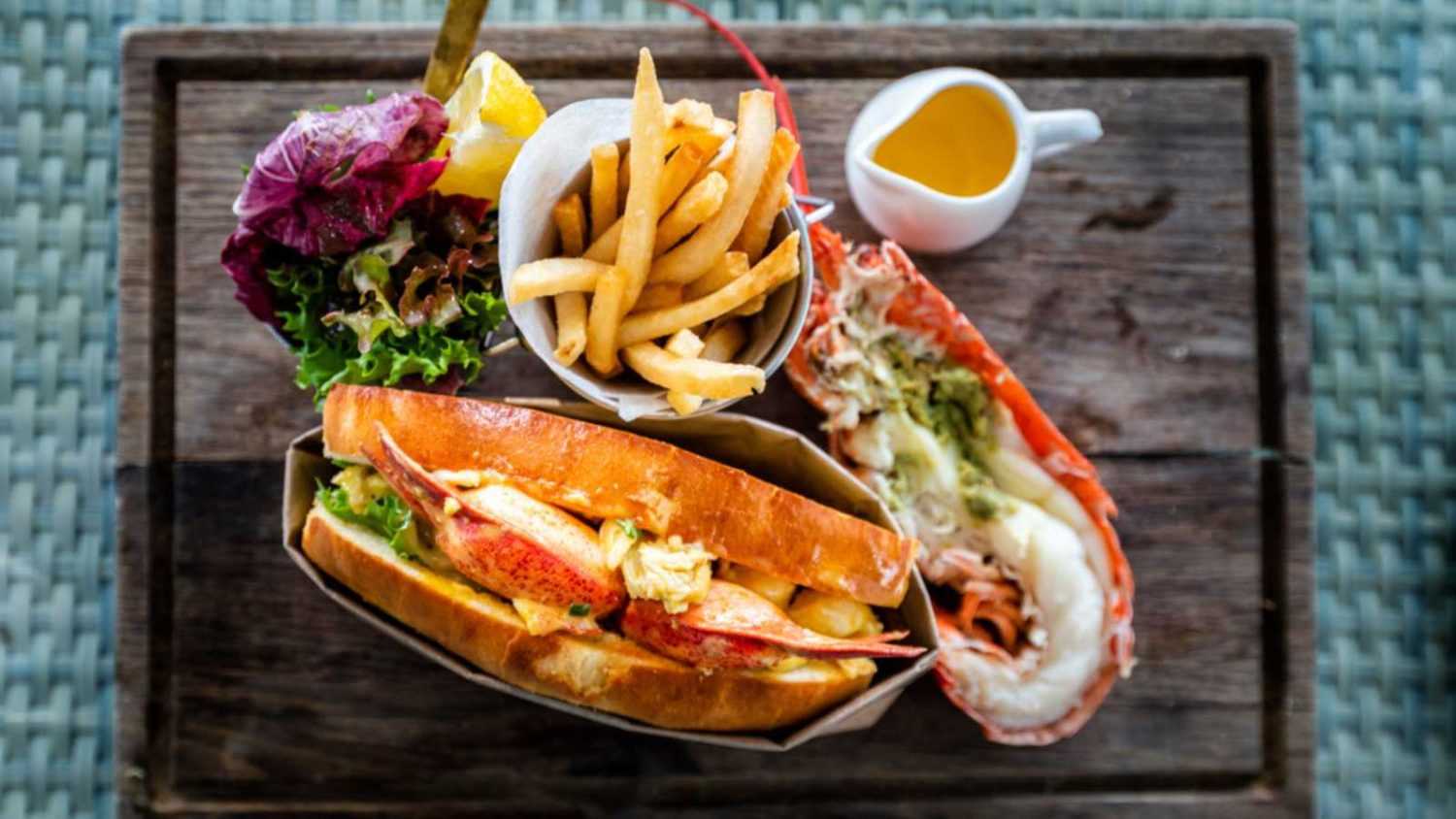 Delicious lobster roll sandwich Served with a side of French Fries and fresh salad. New England lobster roll