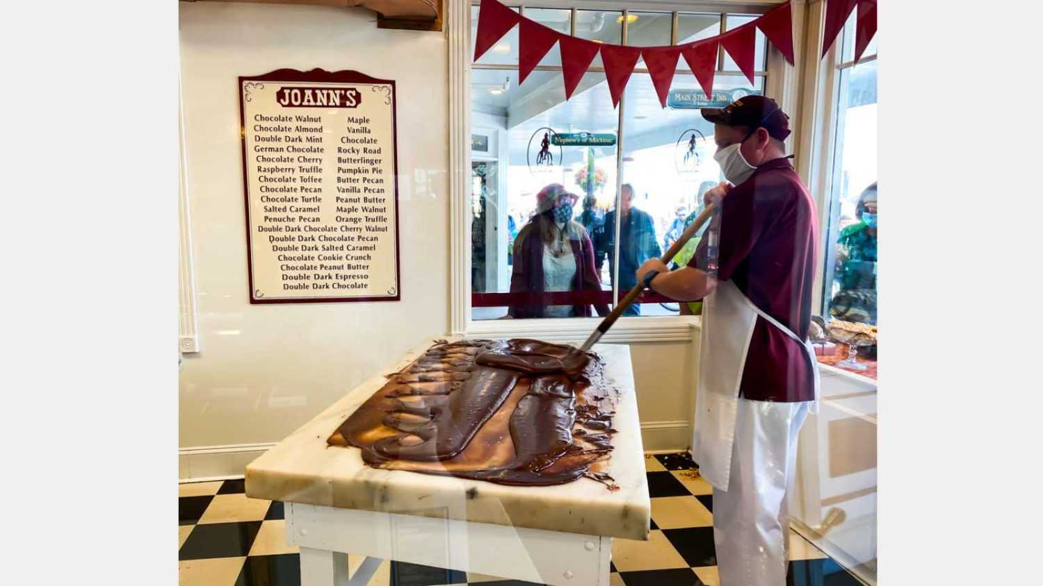 MACKINAC ISLAND, MI, USA- September 6, 2020: A worker paddles the fudge and preparing fresh fudge in shop of downtown Mackinac Island, MI. Fudge is one of the biggest products sold on the island.