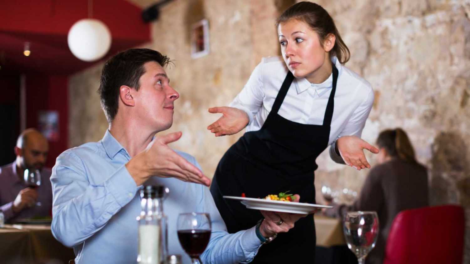 Man talking to waitress at restaurant