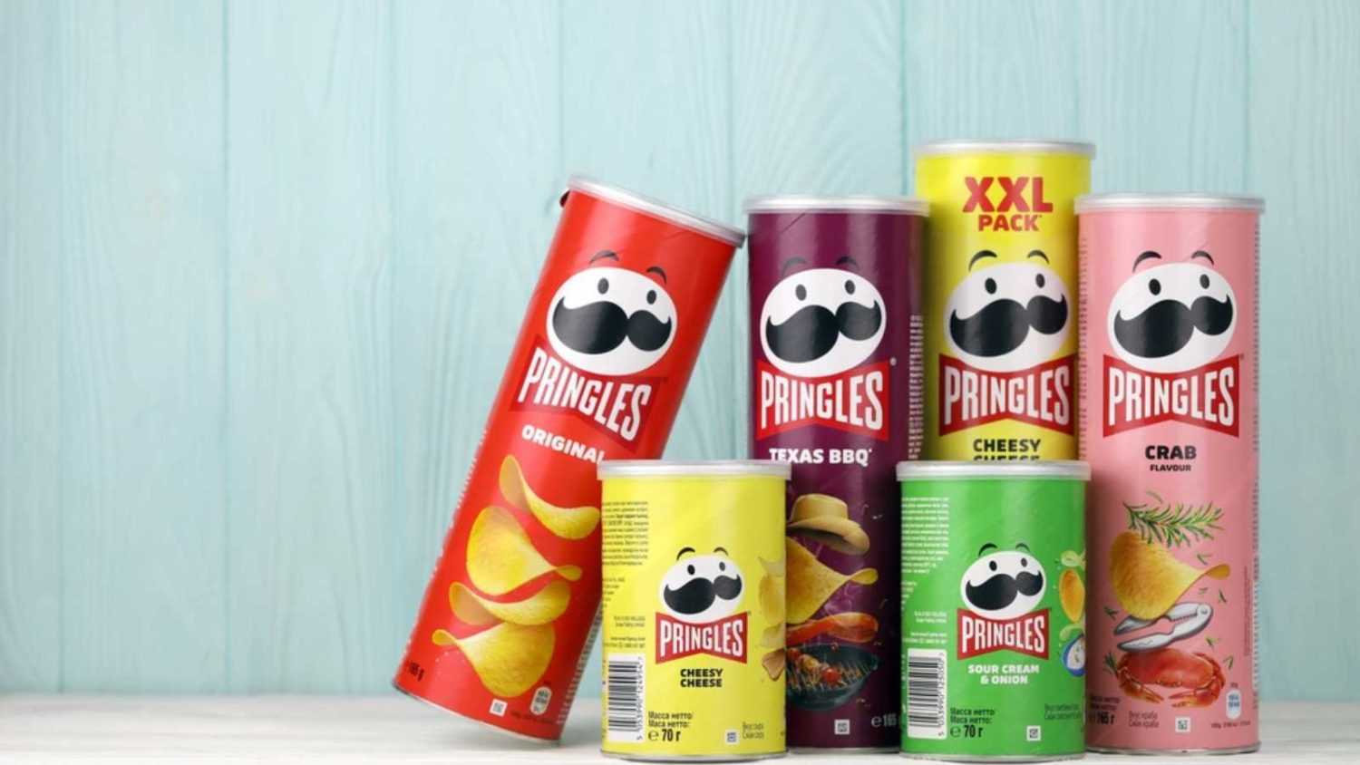 KHARKIV, UKRAINE - DECEMBER 16, 2021: Pringles production with new logo. Pringles is a brand of potato snack chips owned by the Kellogg Company