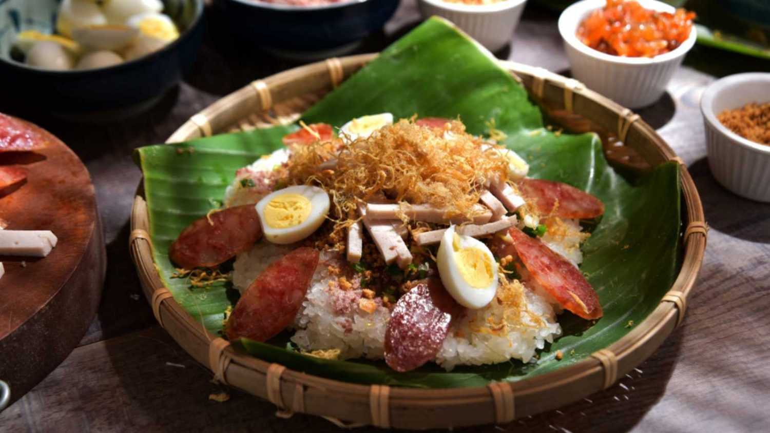 Vietnamese sticky rice (Xoi man). Sticky riced is cooked then steamed and added with topping such as pork sausage, pork floss, oiled scallions, and cooked eggs. The food is sold on street & cheap. 