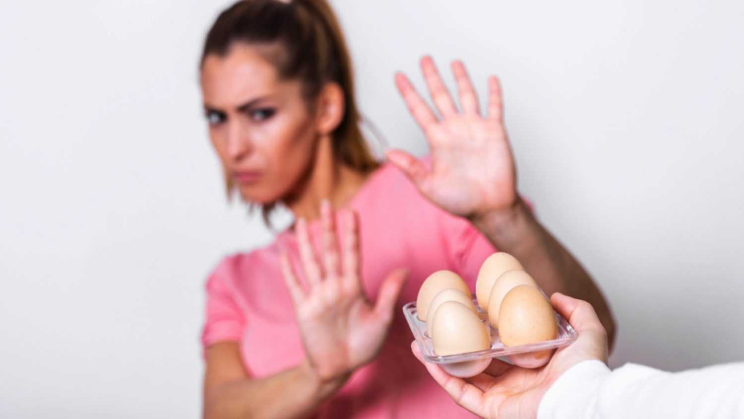 Woman saying no to raw eggs