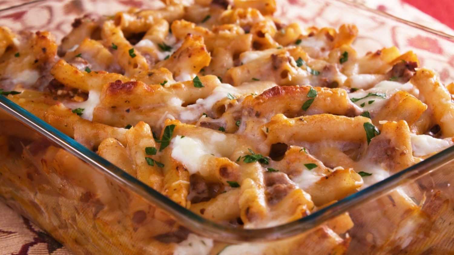 Baked ziti pasta with meat, tomato sauce, mozzarella, parmesan, and ricotta cheese.