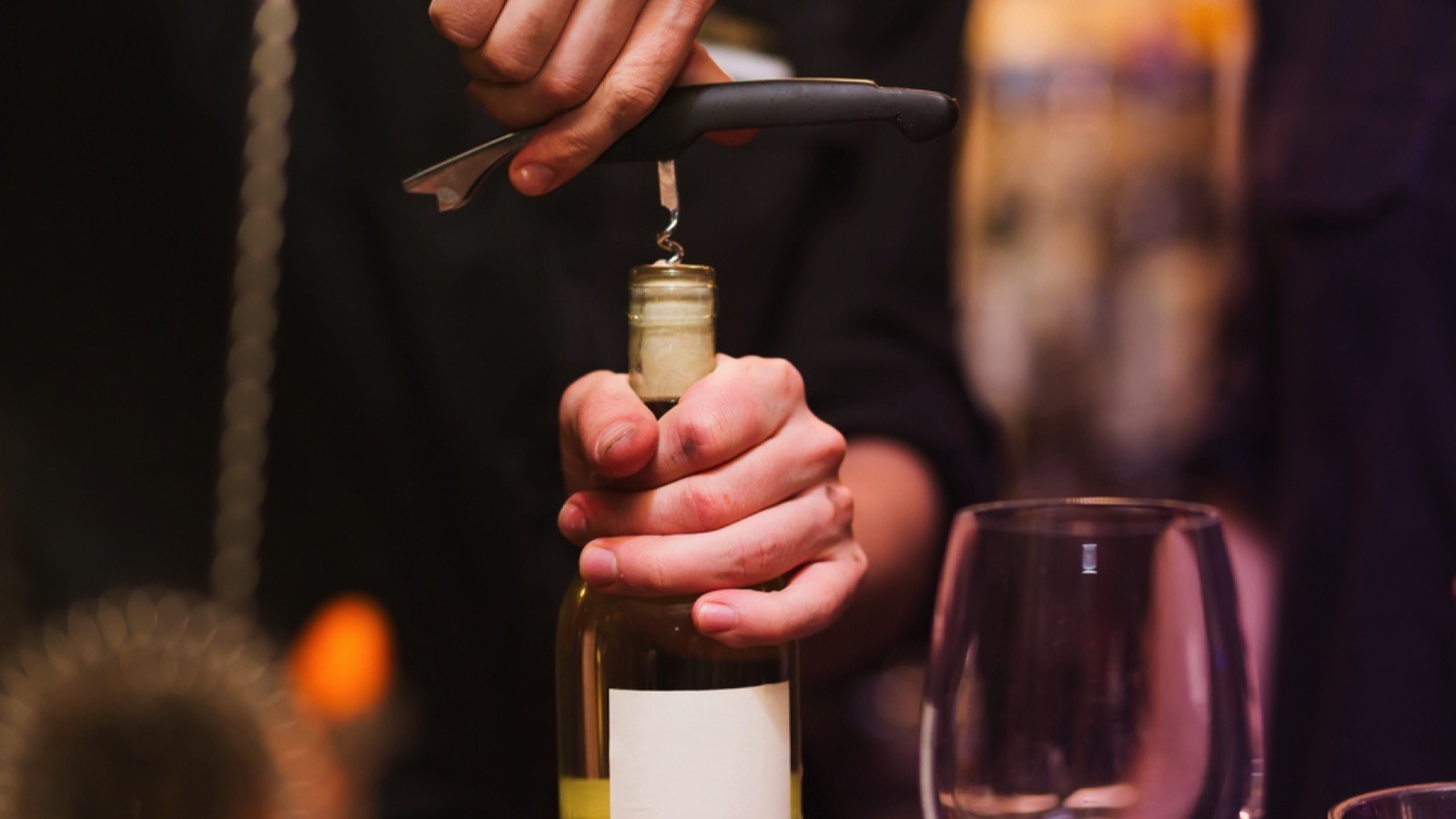 Opening wine bottle with wine opener
