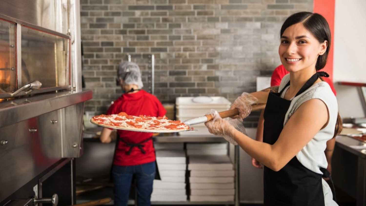 Woman cooking Pizza