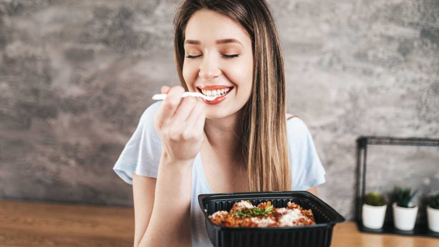 Woman eating and enjoying food