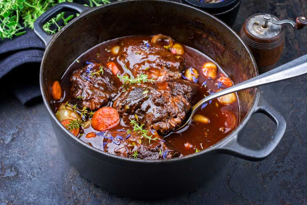 Braised Beef with a scoop in a pan.