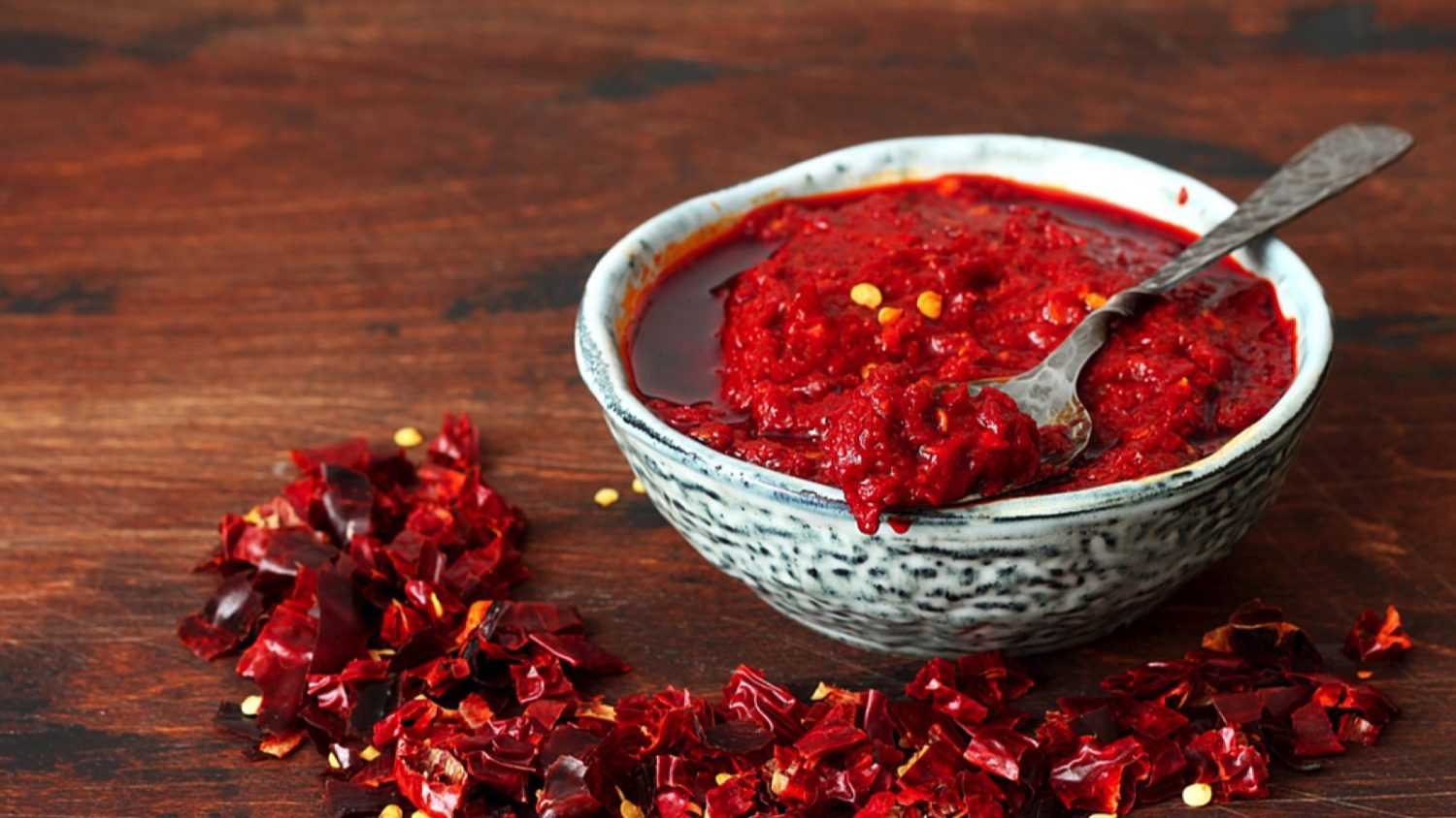 Traditional Homemade Harissa Sauce on a wooden background