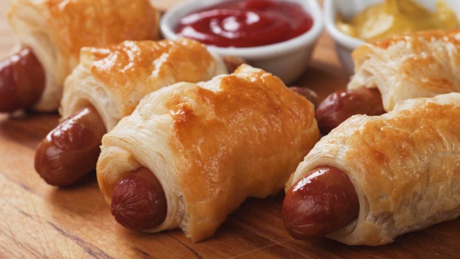 Pigs in blanket, sausage rolls with ketchup and mustard