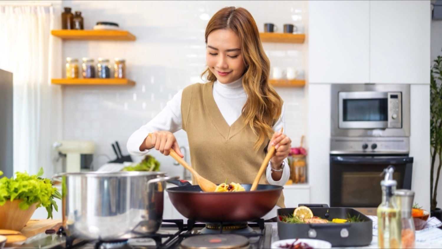 Asian woman cooking happily