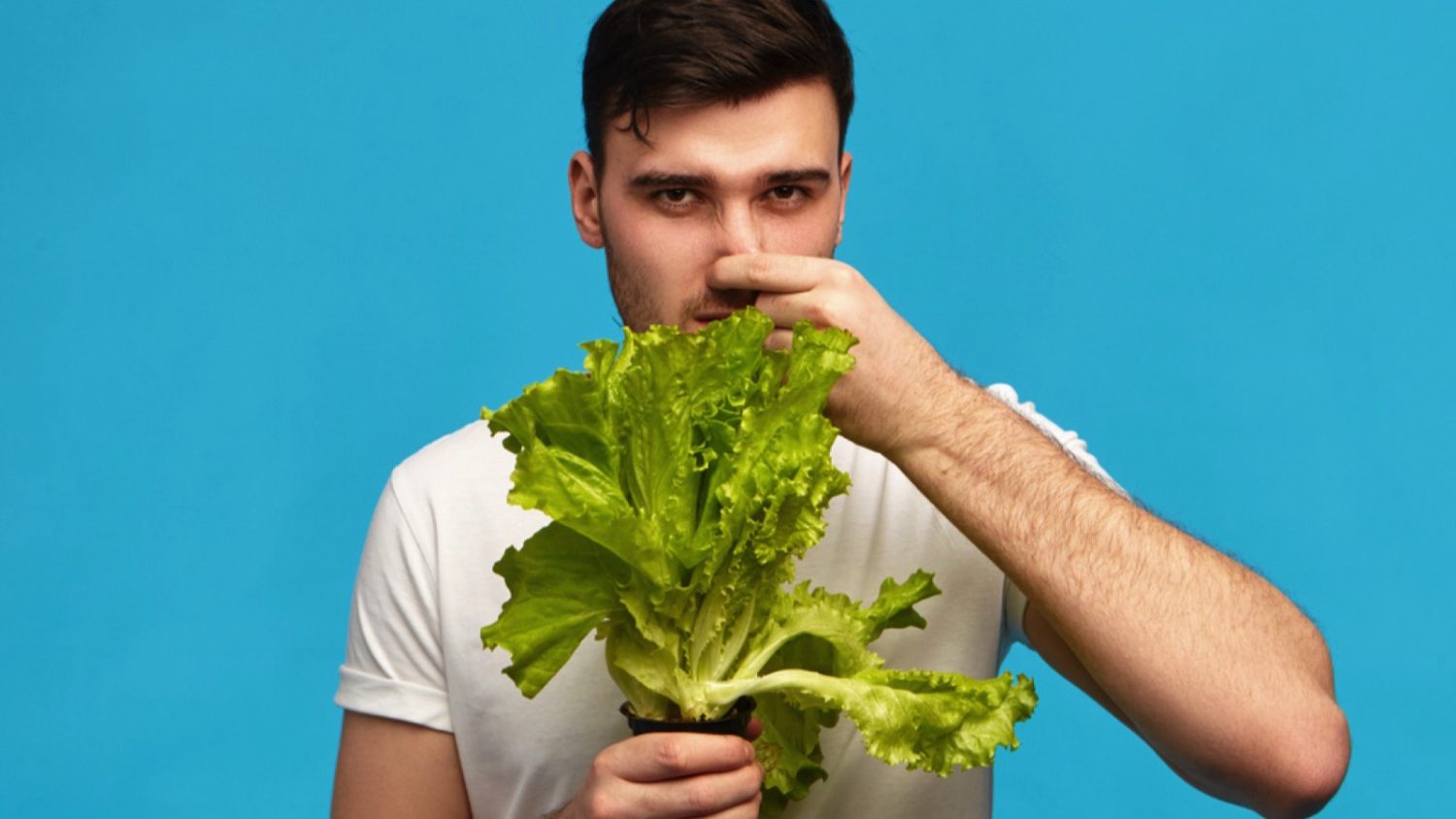 Man disliking lettuce