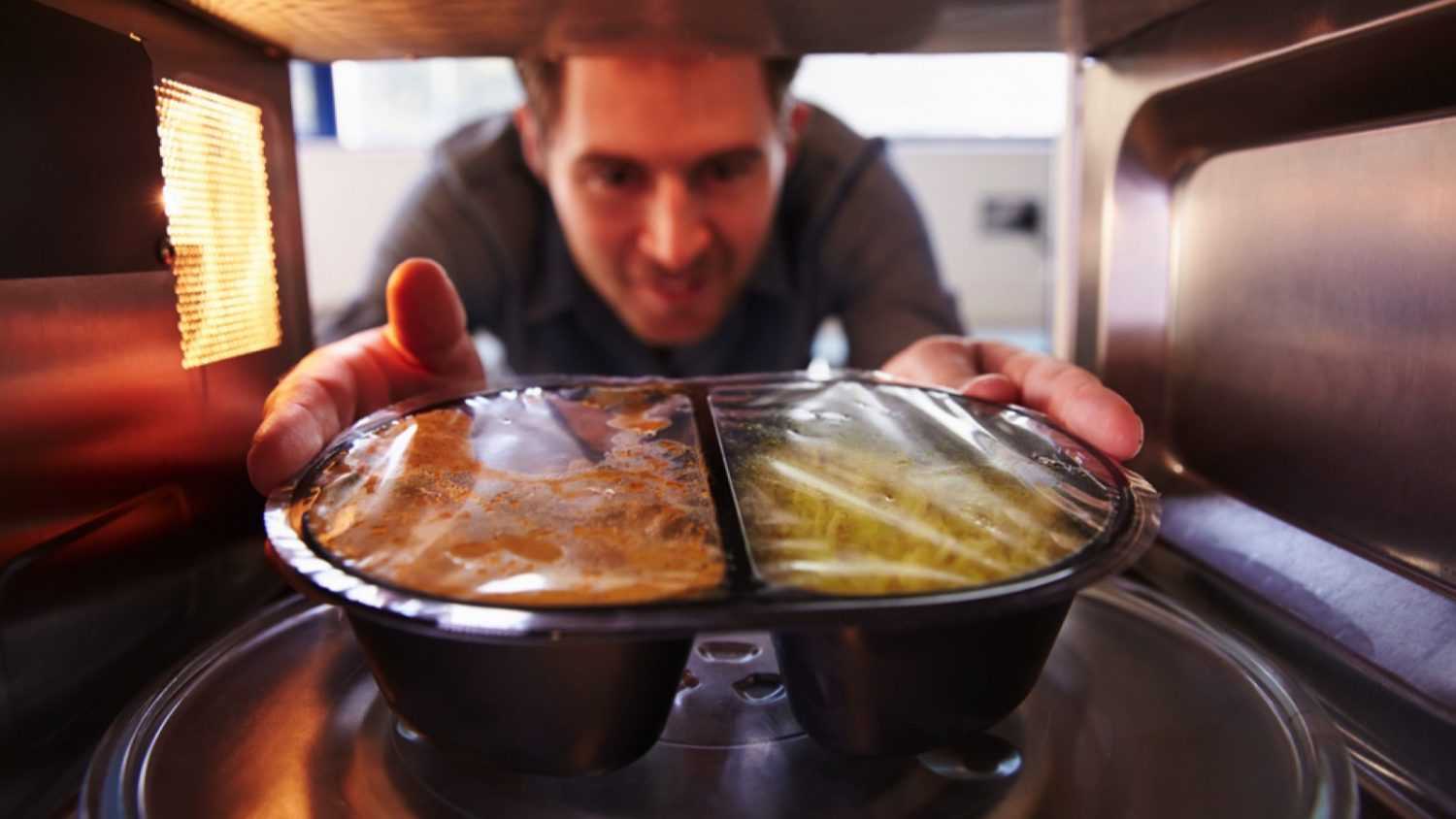 Man heating food in oven