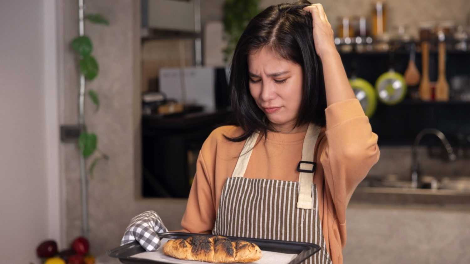Woman Overcooked Burnt Bread from the Oven