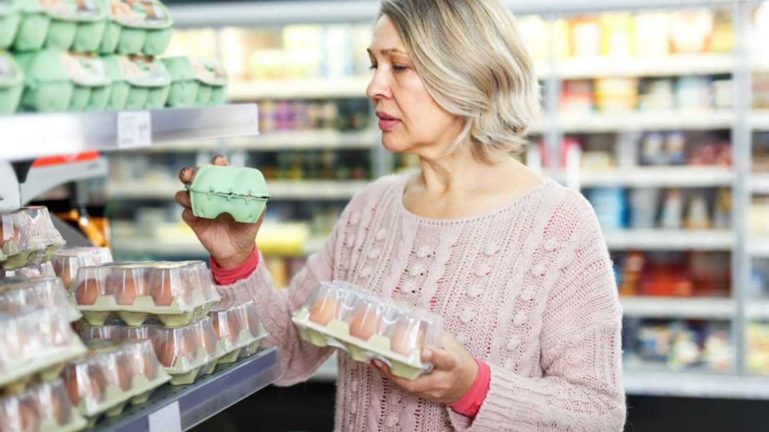 Woman buying raw eggs