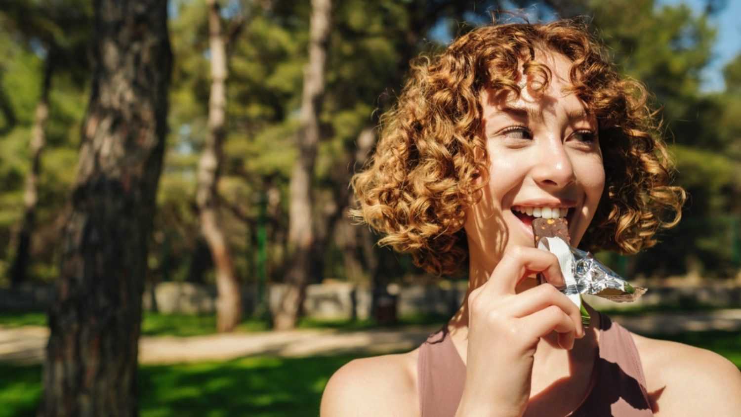 Woman eating Protein Bar
