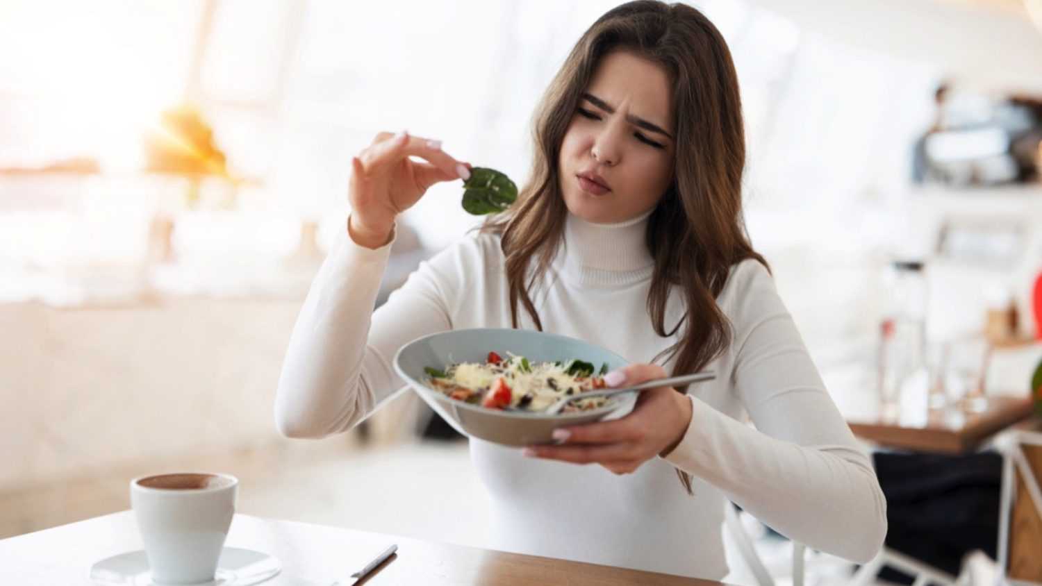 Woman eating food unsatisfied