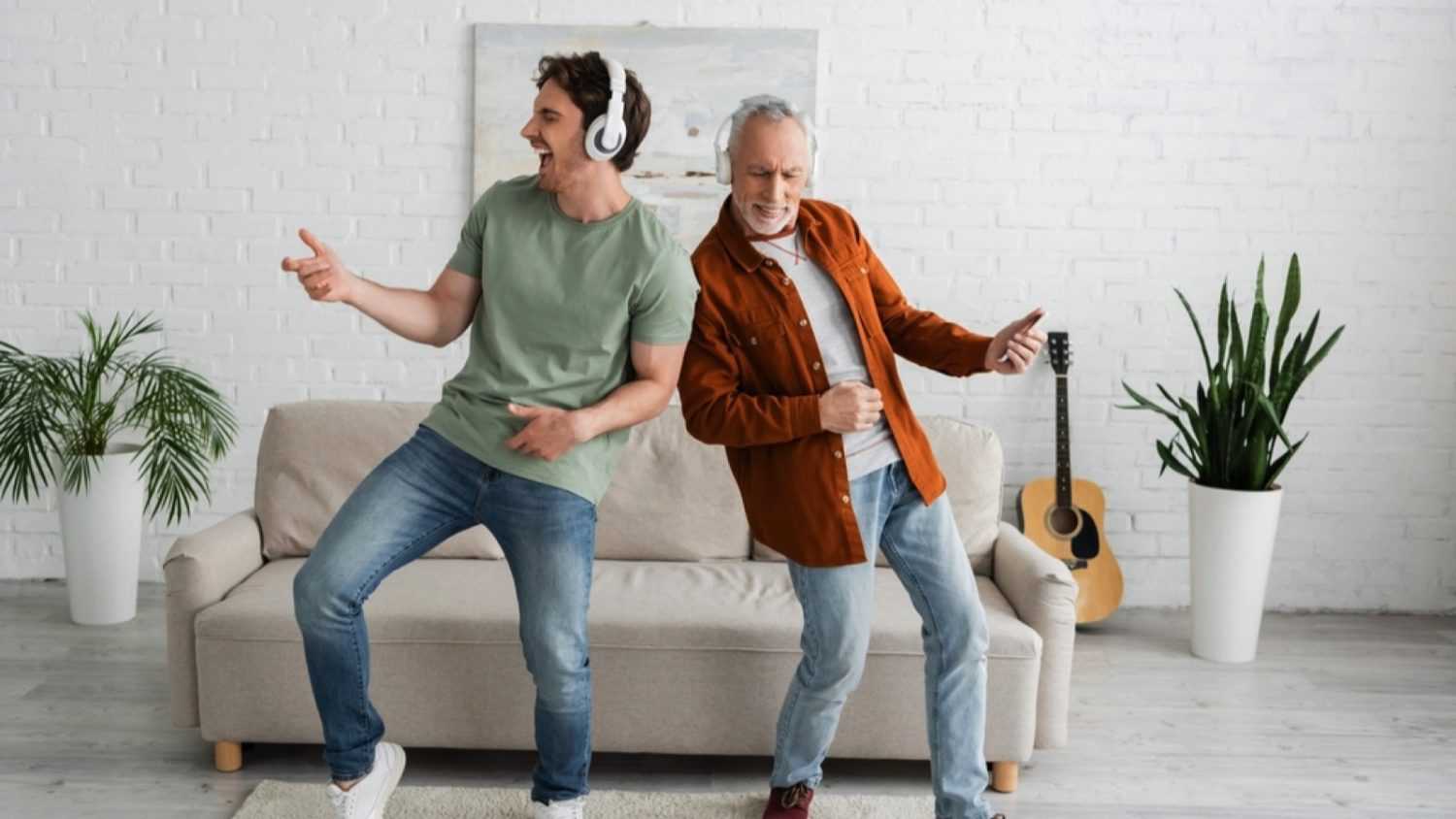 Father and son listening to music and dancing