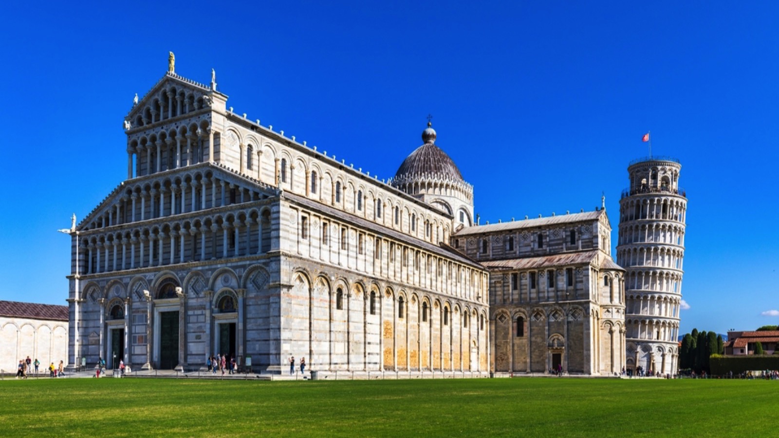 Pisa, Italy - 23 October 2021: Pisa Cathedral and the Leaning Tower in a sunny day in Pisa, Italy. Cathedral with Leaning Tower of Pisa on Piazza dei Miracoli, Tuscany, Italy.