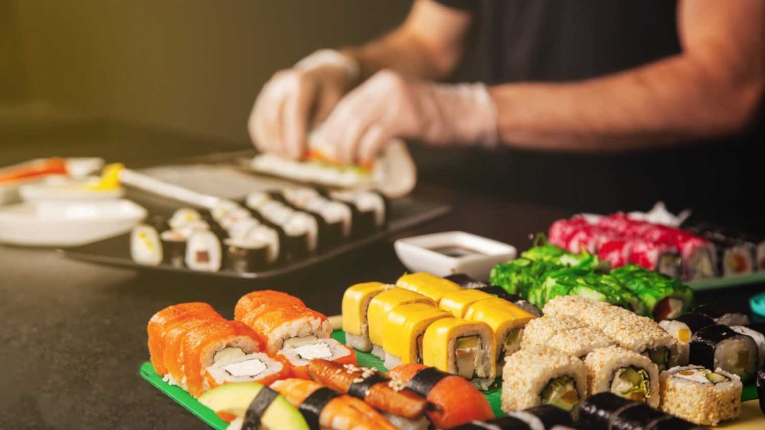 Preparing sushi rolls
