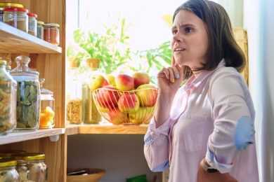 Woman confused and thinking in pantry