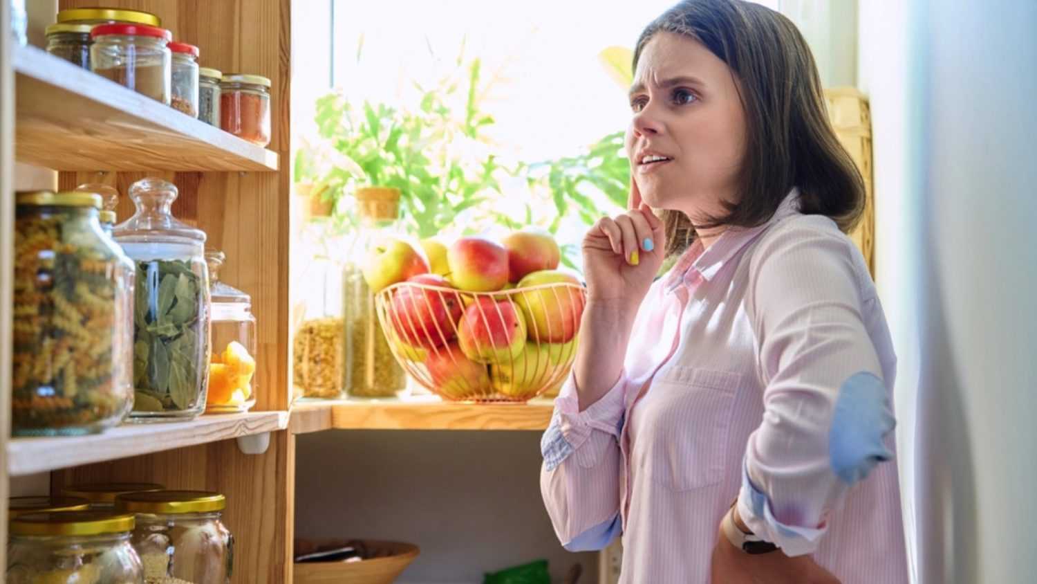 Woman confused and thinking in pantry