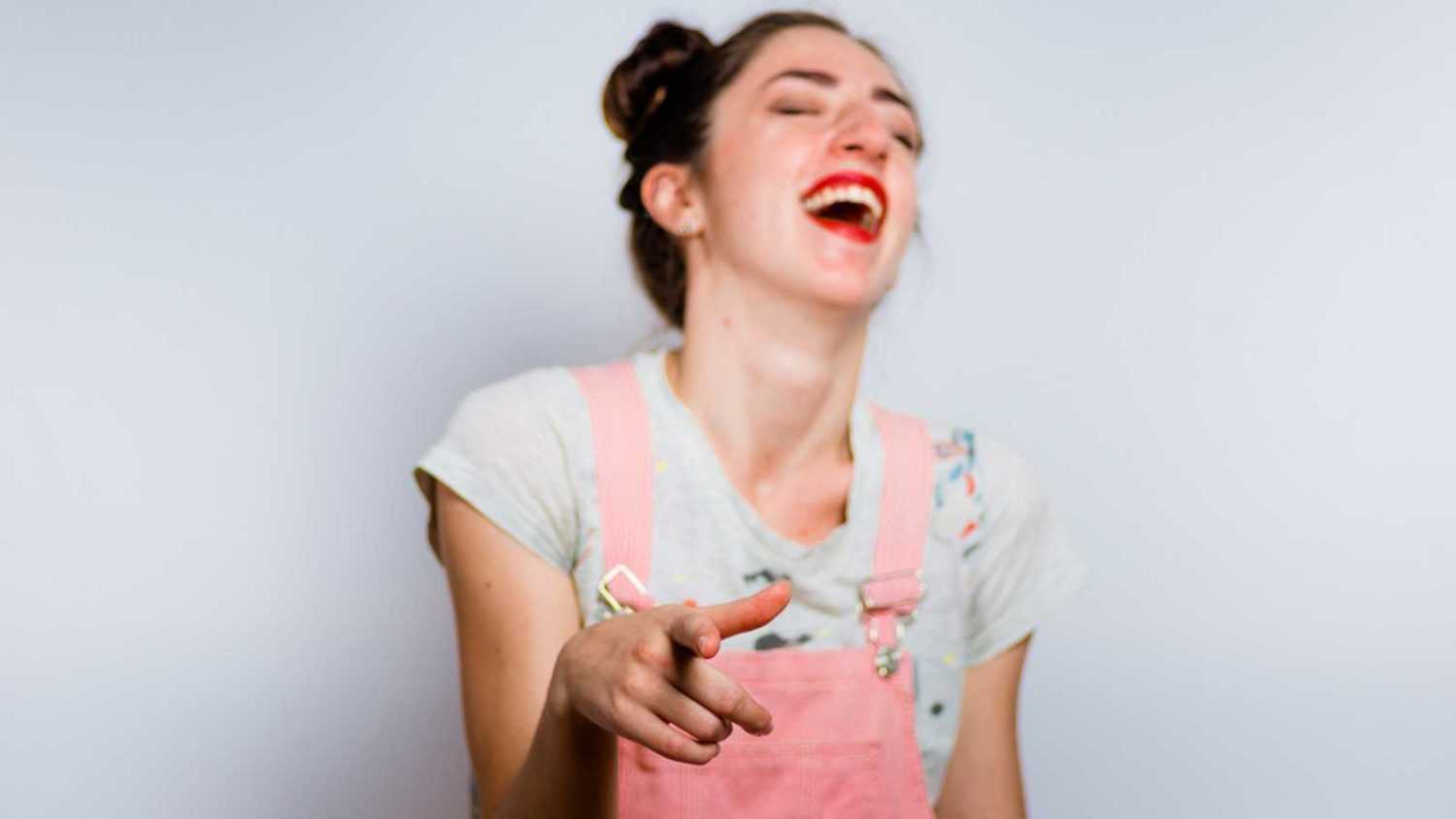 Woman pinpointing and laughing