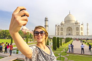 Woman taking selfie in Taj Mahal